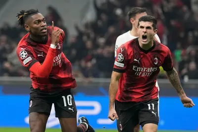 AC Milan's Rafael Leao celebrates with AC Milan's Christian Pulisic, right, after scoring a goal with an overhead kick during the Champions League group F soccer match between AC Milan and Paris Saint Germain at the San Siro stadium in Milan, Italy, Tuesday, Nov. 7, 2023. (AP Photo/Antonio Calanni)

- XCHAMPIONSLEAGUEX