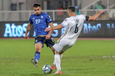 Israel's Neta Lavi, right, and Kosovo's Florian Loshaj, left, challenge for the ball during the Euro 2024 group I qualifying soccer match between Kosovo and Israel at the Fadil Vokrri stadium in Pristina, Kosovo, Sunday, Nov. 12, 2023. (AP Photo/Visar Kryeziu)

- XEURO2024X