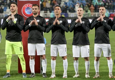 Israel's players gesture and sing the Israeli national anthem prior to the Euro 2024 group I qualifying soccer match between Kosovo and Israel at the Fadil Vokrri stadium in Pristina, Kosovo, Sunday, Nov. 12, 2023. (AP Photo/Visar Kryeziu)

- XEURO2024X