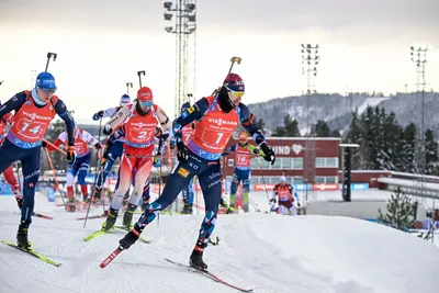 Norway's Sturla Holm LĂ¦greid leads Italy's Lukas Hofer, left,  and Switzerland's Niklas Hartweg during the Single Mixed Relay event of the IBU World Cup Biathlon in Ostersund, Sweden, Saturday, Nov. 25, 2023. (Anders Wiklund/TT News Agency via AP)