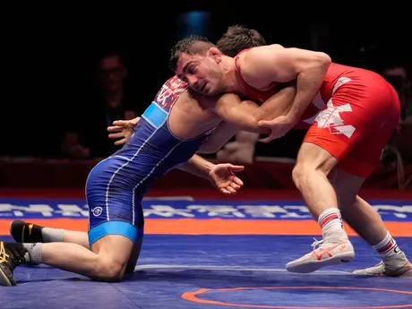 Turkey's Soner Demitas, left, competes with Slovakia's Taimuraz Salkazanov in a men's freestyle 74 kg category gold medal wrestling match during the European Wrestling Championships, in Bucharest, Romania, Sunday, Feb. 18, 2024. (AP Photo/Andreea Alexandru)