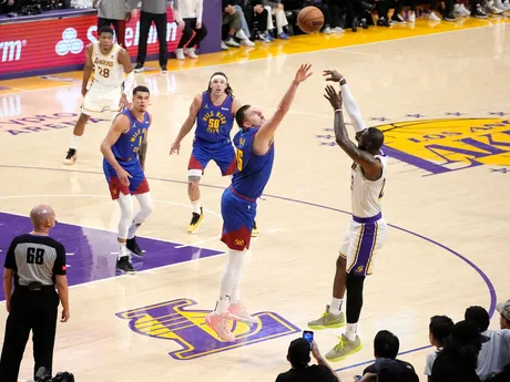LeBron James strieľa cez Nikolu Jokiča počas zápasu Lakers Nuggets.