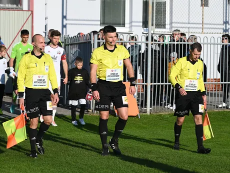 Zľava rozhodcovia stretnutia Tomáš Roszbeck, Peter Ziemba a Tomáš Vorel s nápisom na prednej strane dresu "Staň sa rozhodcom" počas odvetného zápasu semifinále.