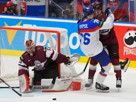Brankár Kristers Gudlevskis, Martin Pospíšil a Karlis Cukste v zápase Slovensko - Lotyšsko v skupine B na MS v hokeji 2024.