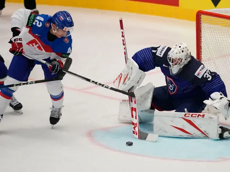 France's goalkeeper Sebastian Ylonen, right, makes a save in front of Slovakia's Martin Fehervary during the preliminary round match between France and Slovakia at the Ice Hockey World Championships in Ostrava, Czech Republic, Saturday, May 18, 2024. (AP Photo/Darko Vojinovic)