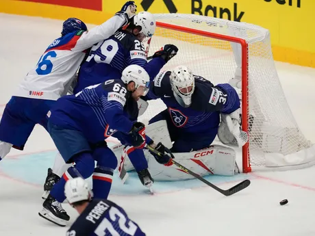 France's goalkeeper Sebastian Ylonen, right, makes a save in front of Slovakia's Martin Pospisil, left, during the preliminary round match between France and Slovakia at the Ice Hockey World Championships in Ostrava, Czech Republic, Saturday, May 18, 2024. (AP Photo/Darko Vojinovic)
