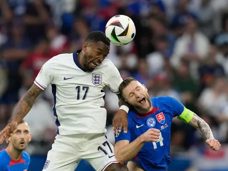 England's Ivan Toney, left, heads the ball past Slovakia's Milan Skriniar during a round of sixteen match between England and Slovakia at the Euro 2024 soccer tournament in Gelsenkirchen, Germany, Sunday, June 30, 2024. (AP Photo/Antonio Calanni)

- XEURO2024X
