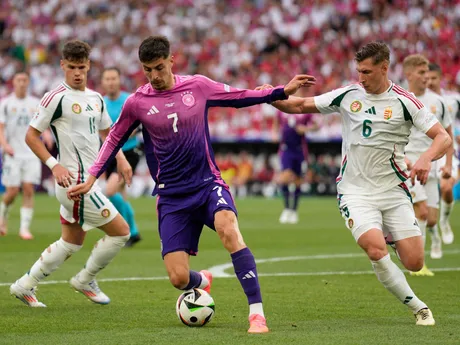 Germany's Kai Havertz, centre, challenges for the ball with Hungary's Willi Orban during a Group A match between Germany and Hungary at the Euro 2024 soccer tournament in Stuttgart, Germany, Wednesday, June 19, 2024. (AP Photo/Ariel Schalit)

- XEURO2024X