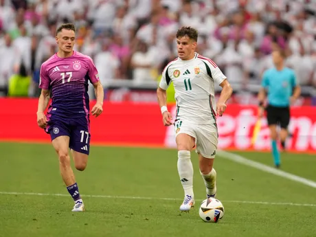 Hungary's Milos Kerkez, right, dribbles past Germany's Florian Wirtz during a Group A match between Germany and Hungary at the Euro 2024 soccer tournament in Stuttgart, Germany, Wednesday, June 19, 2024. (AP Photo/Darko Vojinovic)

- XEURO2024X