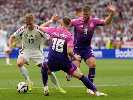 Hungary's Andras Schafer, left, challenges for the ball with Hungary's Zsolt Nagy and Martin Adam during a Group A match between Germany and Hungary at the Euro 2024 soccer tournament in Stuttgart, Germany, Wednesday, June 19, 2024. (AP Photo/Antonio Calanni)

- XEURO2024X