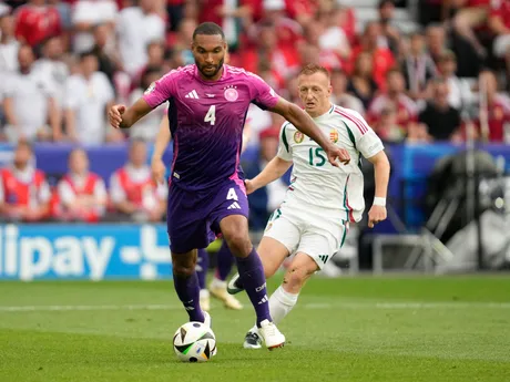 Germany's Jonathan Tah (4) controls the ball in fron of Hungary's Laszlo Kleinheisler (15) during a Group A match between Germany and Hungary at the Euro 2024 soccer tournament in Stuttgart, Germany, Wednesday, June 19, 2024. (AP Photo/Darko Vojinovic)

- XEURO2024X