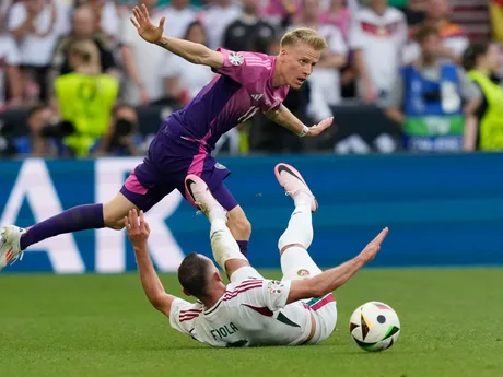 Germany's Chris Fuehrich, left, challenges for the ball with Hungary's Attila Fiola during a Group A match between Germany and Hungary at the Euro 2024 soccer tournament in Stuttgart, Germany, Wednesday, June 19, 2024. (AP Photo/Antonio Calanni)

- XEURO2024X
