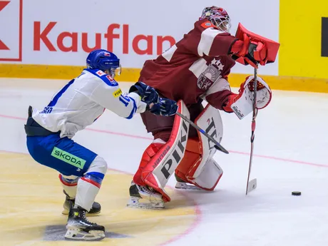 Adam Lukošik (Slovensko), Eriks Vitols (Lotyšsko) počas Vianočného Kaufland Cupu v hokeji Slovensko - Lotyšsko.