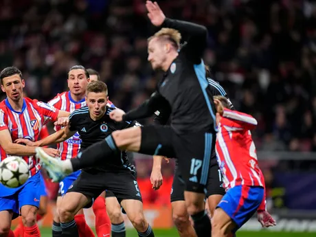 Jurij Medvedev (Slovan) pri strele v súboji o loptu v zápase 6. kola ligovej fázy Ligy majstrov Atlético Madrid - Slovan Bratislava.