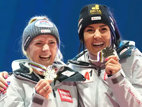 Austria's Katharina Truppe, left, and Austria's Stephanie Venier show their bronze medal in a women's team combined event, at the Alpine Ski World Championships, in Saalbach-Hinterglemm, Austria, Tuesday, Feb. 11, 2025. (AP Photo/Giovanni Auletta)