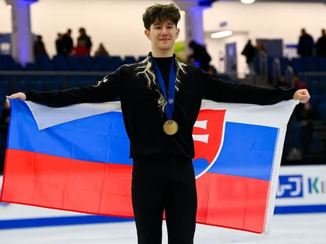 Slovenský krasokorčuliar Adam Hagara sa raduje so slovenskou vlajkou a bronzovou medailou po majstrovstvách sveta juniorov v maďarskom Debrecíne.