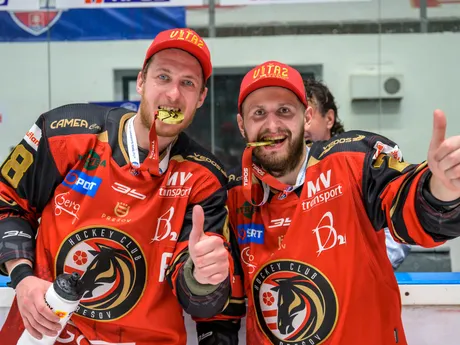 Na snímke hráči Prešova zľava Samuel Chalupa a František Pulščák hryzú zlaté medaily počas osláv z postupu do slovenskej extraligy po piatom zápase finále play off hokejovej Tipos SHL HC Prešov - HK Skalica.