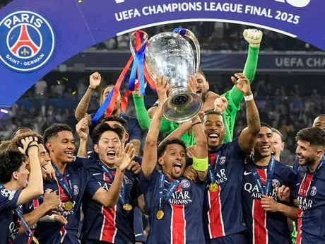 PSG's Marquinhos holds up the trophy as he celebrates with his teammates after winning the Champions League final soccer match between Paris Saint-Germain and Inter Milan at the Allianz Arena in Munich, Germany, Saturday, May 31, 2025. (AP Photo/Martin Meissner)

- XCHAMPIONSLEAGUEX