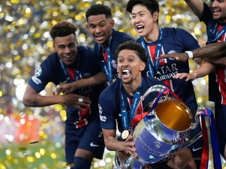 PSG's team captain Marquinhos holds the trophy after winning the Champions League final soccer match between Paris Saint-Germain and Inter Milan at the Allianz Arena in Munich, Germany, Saturday, May 31, 2025. (AP Photo/Luca Bruno)

- XCHAMPIONSLEAGUEX