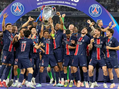 PSG's Marquinhos holds up the trophy as he celebrates with his teammates after winning the Champions League final soccer match between Paris Saint-Germain and Inter Milan at the Allianz Arena in Munich, Germany, Saturday, May 31, 2025. (AP Photo/Martin Meissner)

- XCHAMPIONSLEAGUEX