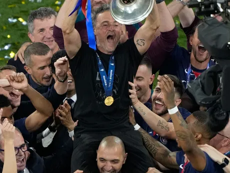 PSG's head coach Luis Enrique lifts the trophy after winning the Champions League tournament at the Allianz Arena in Munich, Germany, Saturday, May 31, 2025. (AP Photo/Michael Probst)

- XCHAMPIONSLEAGUEX
