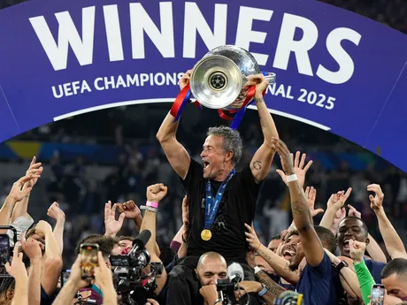 PSG's head coach Luis Enrique holds up the trophy as he celebrates with his players after winning the Champions League final soccer match between Paris Saint-Germain and Inter Milan at the Allianz Arena in Munich, Germany, Saturday, May 31, 2025. (AP Photo/Martin Meissner)

- XCHAMPIONSLEAGUEX