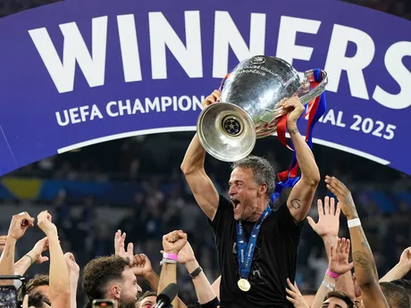 PSG's head coach Luis Enrique holds up the trophy as he celebrates with his players after winning the Champions League final soccer match between Paris Saint-Germain and Inter Milan at the Allianz Arena in Munich, Germany, Saturday, May 31, 2025. (AP Photo/Martin Meissner)

- XCHAMPIONSLEAGUEX