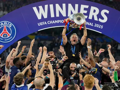 PSG's head coach Luis Enrique holds up the trophy as he celebrates with his players after winning the Champions League final soccer match between Paris Saint-Germain and Inter Milan at the Allianz Arena in Munich, Germany, Saturday, May 31, 2025. (AP Photo/Martin Meissner)

- XCHAMPIONSLEAGUEX