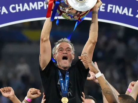 PSG's head coach Luis Enrique celebrates with the trophy after winning the Champions League final soccer match between Paris Saint-Germain and Inter Milan at the Allianz Arena in Munich, Germany, Saturday, May 31, 2025. (AP Photo/Matthias Schrader)

- XCHAMPIONSLEAGUEX