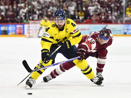 Hráč Švédska Rasmus Andersson a Lotyš Glebs Prohorenkovs v zápase A-skupiny Lotyšsko - Švédsko na MS v hokeji 2025.