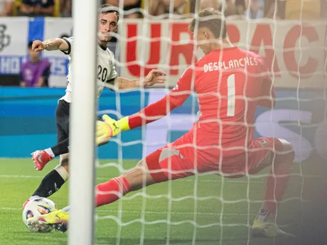 Paul Nebel (Nemecko) a vpravo brankár Sebastiano Desplanches (Taliansko) vyráža strelu počas zápasu Nemecko - Taliansko vo štvrťfinále na EURO U21 2025 (ME vo futbale do 21 rokov).