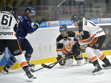 Vľavo Marek Bartánus, tretí zľava Joordan Martell a vpravo Kristofers Bindulis (všetci Michalovce) a druhý zľava Adam Cracknell (Poprad) bojujú puk v zápase 13. kola hokejovej Tipos extraligy HK Dukla Michalovce - HK Poprad.