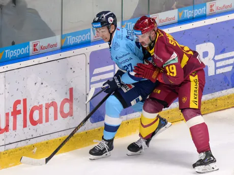 Na snímke zľava Sebastián Čederle (Nitra) a Tomáš Starosta (Trenčín) bojujú o loptu v zápase 28. kola hokejovej Tipsport ligy HK Nitra - HK Dukla Trenčín.