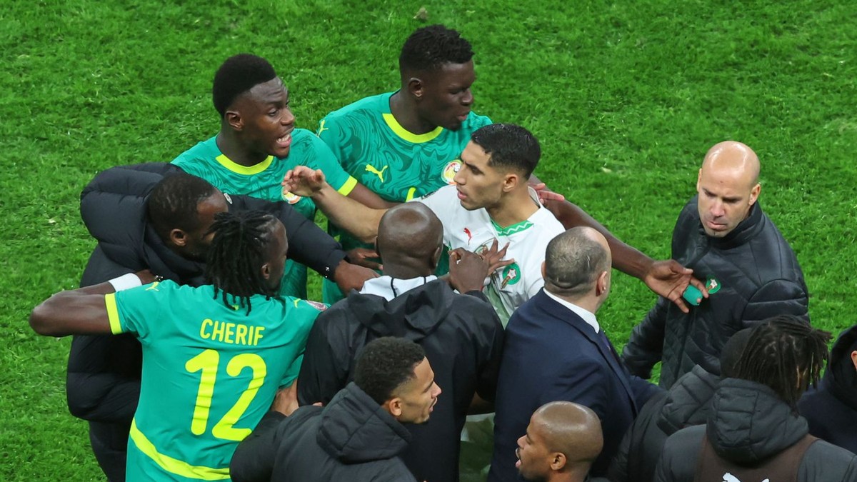 Morocco's Achraf Hakimi, center, clashes with Senegal players after a controversial penalty was awarded to Morocco late on during the Africa Cup of Nations final soccer match between Senegal and Morocco in Rabat, Morocco, Sunday, Jan. 18, 2026. (AP Photo/Youssef Loulidi)