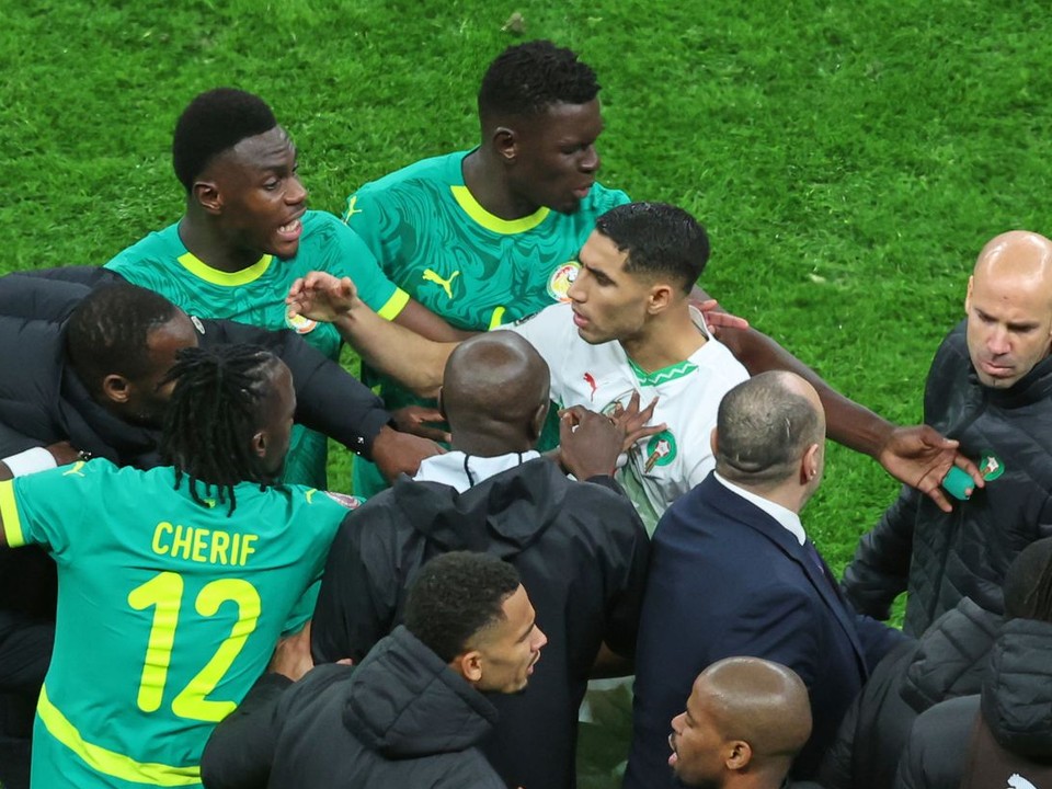 Morocco's Achraf Hakimi, center, clashes with Senegal players after a controversial penalty was awarded to Morocco late on during the Africa Cup of Nations final soccer match between Senegal and Morocco in Rabat, Morocco, Sunday, Jan. 18, 2026. (AP Photo/Youssef Loulidi)