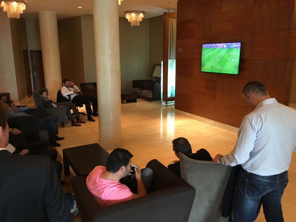 Delegáti sledujú futbal.