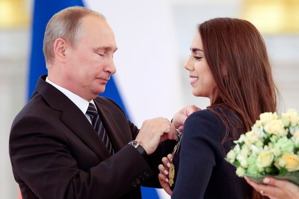 Ruský prezident Vladimir Putin pripína vyznamenanie zlatej medailistke, ruskej atlétke v modernej gymnastike Margarite Mamunovej počas odovzdávania vyznamenaní pre členov ruskej olympijskej výpravy po ich príchode z OH 2016 v Rio de Janeiro 25. augusta 2016.