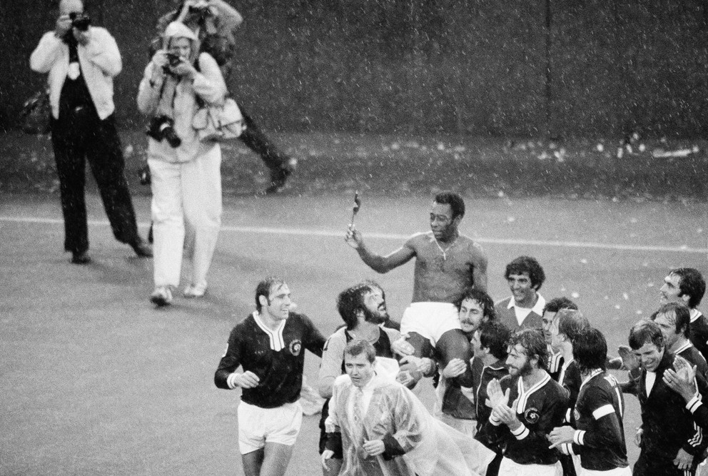 Pelé je odnesený z ihriska Giants Stadium svojimi spoluhráčmi z New York Cosmos po jeho poslednom futbalovom zápase v East Rutherford, New Jersey, 1. októbra 1977. Usmievajúci sa a hľadiaci na Peleho sú Giorgio Chinaglia z Talianska a Erol Yasin z Turecka, stred.