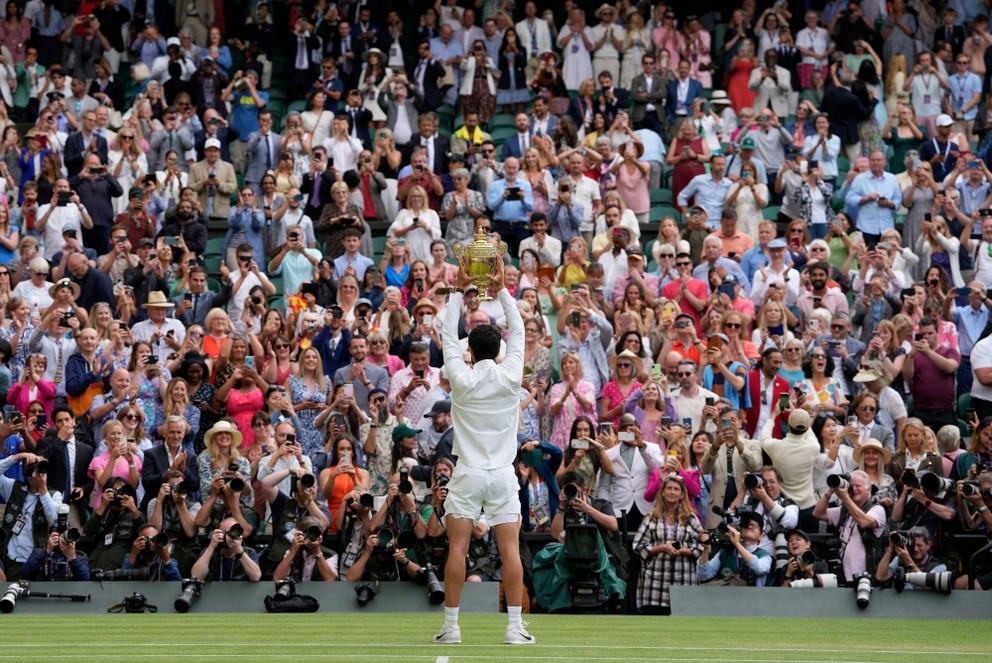 Španiel Carlos Alcaraz pózuje s trofejou pre víťaza Wimbledonu. 
