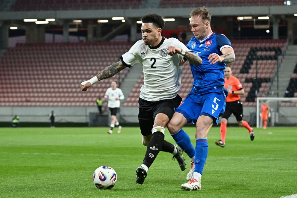 Pictured on the right of the Slovak player Dominik Javorček and Germany player Nnamdi Collins during the preparatory match between Slovakia 21 - Germany 21.