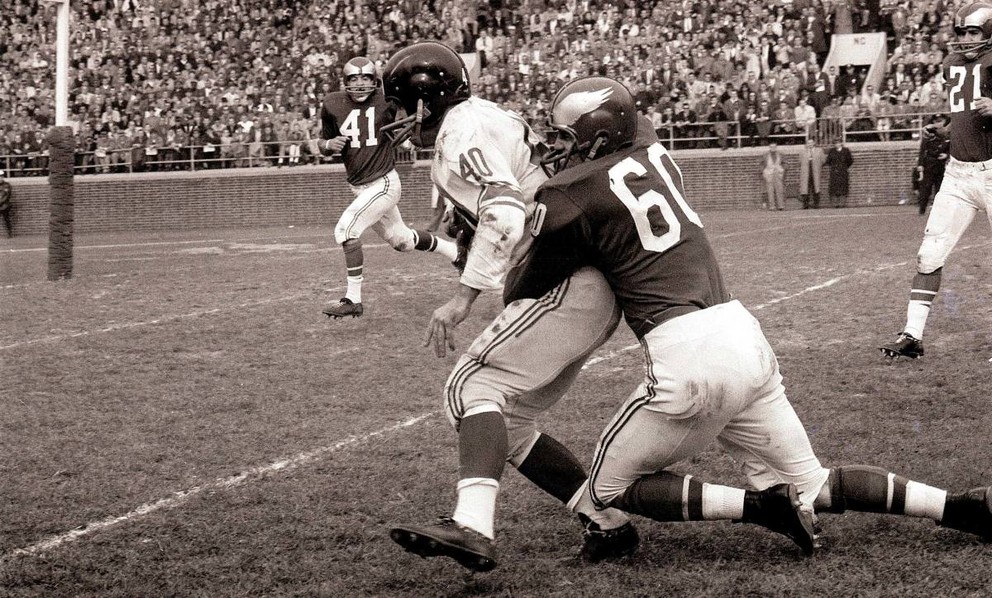 Chuck Bednarik from Philadelphia Eagles prevents Joe Morrison from New York Giants.