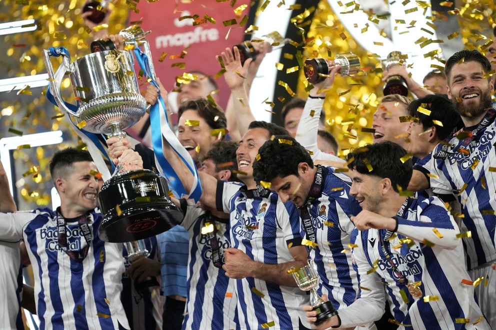 Futbalista Realu Sociedad Mikel Oyarzabal (uprostred) zdvíha trofej po zisku Španielskeho pohára
